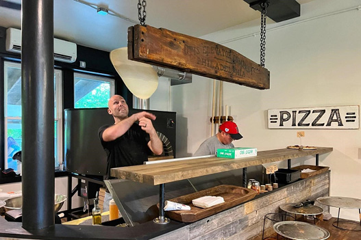 Mill River Tavern employee with pizza dough